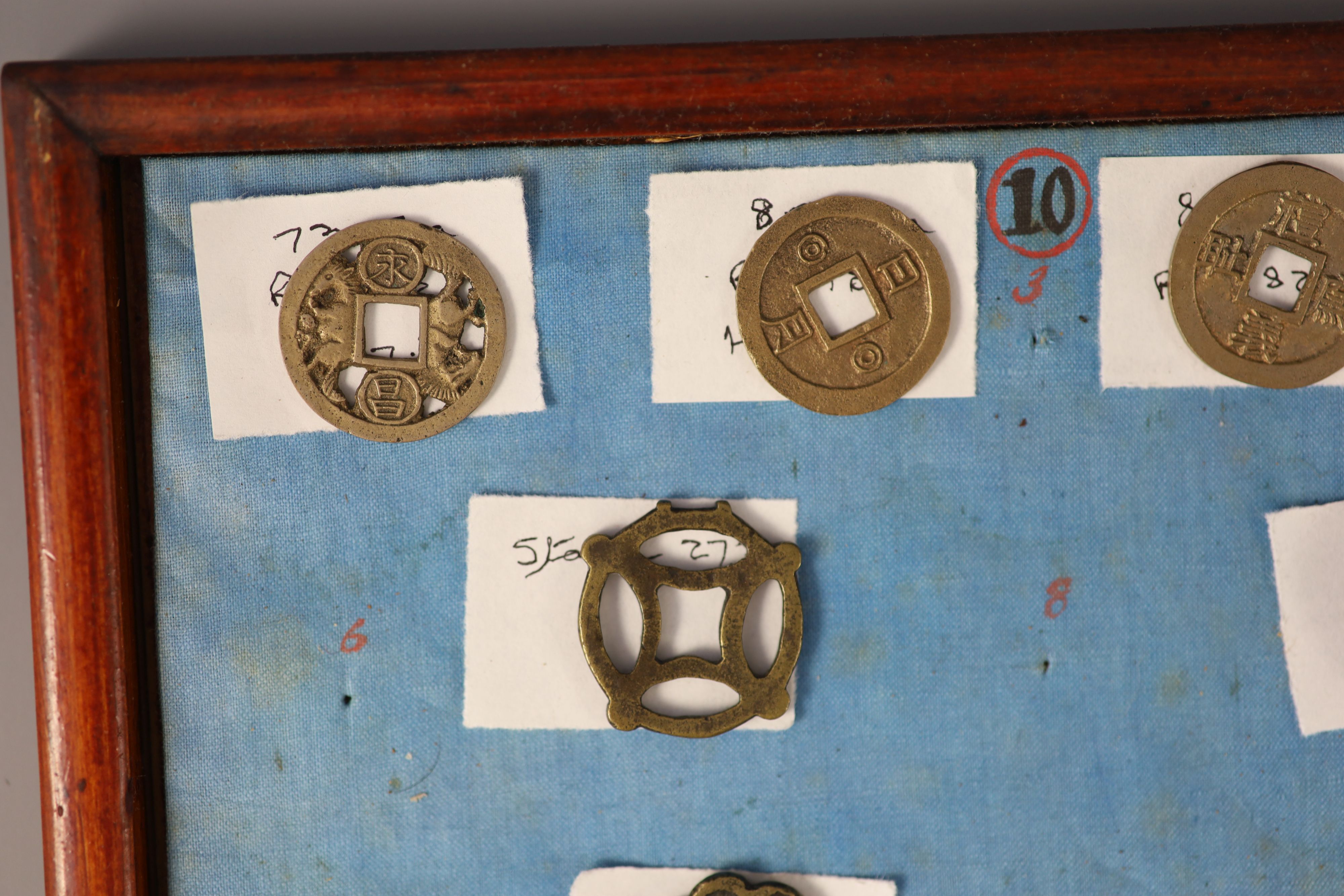 A group of 99 Korean bronze and metal amulets or charms, 19th/20th century